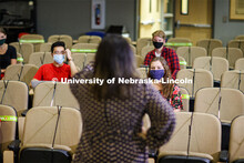 Masked students in an Anderson Hall Lecture Hall are seated for social distancing. Photo shoot of st