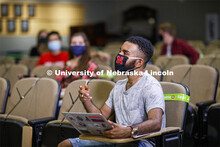 Masked students in an Anderson Hall Lecture Hall are seated for social distancing. Photo shoot of st