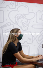 Students wear masks as they study in the Lynn and Dana Roper Media Studio in Anderson Hall. Photo sh