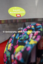 A seat-available sticker marking in Anderson Hall. Photo shoot of students wearing masks and practic