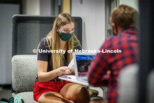 Masked students in Anderson Hall working on computers. Photo shoot of students wearing masks and pra