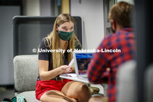Masked students in Anderson Hall working on computers. Photo shoot of students wearing masks and pra
