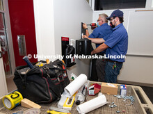 Matt Rivers and Jackson Kelly of Building Systems Maintenance install hand sanitizer, disinfectant w