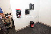 Building Systems Maintenance technicians install hand sanitizer, disinfectant wipes, paper towels, t