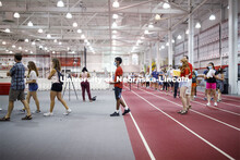 Students social distance as they work their way around the track in Devaney Sports Center to complet