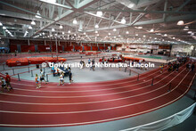 Students social distance as they work their way around the track in Devaney Sports Center to complet