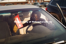 Victoria Thomas of Lincoln hangs her tag for Harper Residence Hall as she and her mom queue up for t
