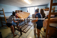 Shanelle Flores' family puts her futon together in her Harper Hall room. First day of residence hall