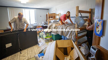 Kailey Trampe of Axtell, NE, smiles for her mom, Sara, as she makes her bed. Kailey's dad, Todd, wor