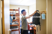 Jack Kinney of Omaha hangs up his backpack in his Knoll Residence Hall room. First day of residence 