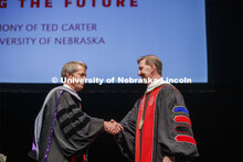 President Ted Carter, right, receives congratulations from Nebraska Regents Chair James D. Pillen af