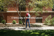 Evan Portz, a junior from Arizona, longboards toward his job at the East Campus student union. First