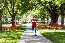 Evan Portz, a junior from Arizona, longboards toward his job at the East Campus student union. First