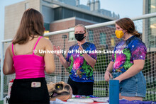 Members of the Nebraska Women’s Ultimate Club speak to a student during the HuskerMania Masker Sin