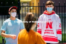 Members of the Nebraska Broomball Club speak to students during the HuskerMania Masker Singer event 