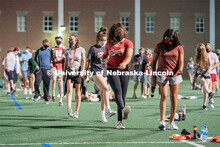 Students perform the Cupid Shuffle during the HuskerMania Masker Singer event at Mabel Lee Fields. A