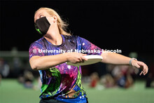Junior Michaela Ott throws a frisbee during the HuskerMania Masker Singer event at Mabel Lee Fields.