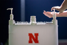 A student makes use of a hand sanitizing station while leaving Mabel Lee Fields at the conclusion of