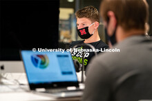 Junior Sports Media and Broadcasting major Peyton Thomas works on homework inside of Andersen Hall d