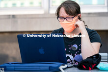 Freshman Journalism major Samantha Grove listens to a lecture through Zoom outside of Andersen Hall 