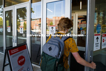 Olivia Benson enters the Carson Center for her class. All the campus doors have been marked to keep 