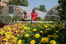 Samatha Clapper (in red) and Emily Steinauer discuss their observation of flowers in their Hort 214 