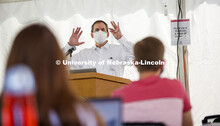 Law Professor Matt Schaefer teaches LAW 671 International Trade Law in a tent set up outdoors at the