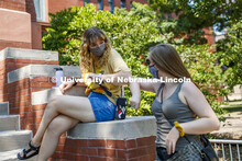 Ciara Allen elbow bumps Frannie Folsom while they wait for their afternoon architecture class to beg