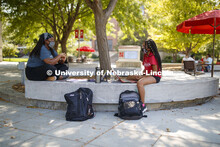 Serenity Loving and Vivian Berry catch up on the details of their first day on campus. First day for