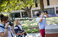 Walker Pickering explains camera settings to Rachel Lesley in the PHOT 161 - Photography for Non-maj