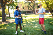 Walker Pickering explains camera settings to a student in the PHOT 161 - Photography for Non-majors 