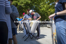 Jack Van Nieuwenhuyse and his Knoll Residence Hall roommate Easton Sckerl look over posters for sale