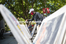 Mohamed Komi looks over posters for sale in front of the Nebraska Union Monday. City Campus. August 