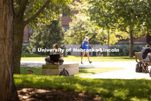 Isabella Kane zooms her class from a shady bench outside of Love Library's Adele Coryell Hall Learni