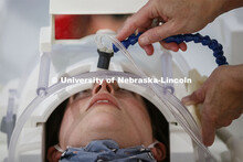 The milkshake mouthpiece is adjusted down to the patients mouth as she lies on the MRI bed. Nebraska