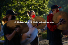 The sunrise reflects off of Skyler Krull's cymbal during the early morning practice. A sunrise seren