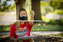 Katie Rice, freshman from Springfield, NE, uses a pencil to help her proportion a tree she is sketch