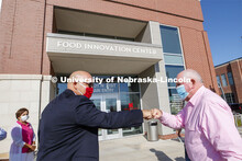 UNL Harlan Vice Chancellor for IANR and NU Vice President Mike Boehm, left, fist bumps United States