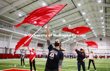 Michaela Smith and the flag team are out for an early morning spin as the Cornhusker Marching Band p