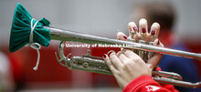 Band members have used ingenuity to cover their horn's bell. Cornhusker Marching Band practice in Co