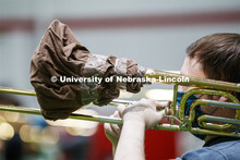 Band members have used ingenuity to cover their horn's bell. Cornhusker Marching Band practice in Co