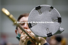 Band members have used ingenuity to cover their horn's bell. Cornhusker Marching Band practice in Co