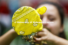 Band members have used ingenuity to cover their horn's bell. Cornhusker Marching Band practice in Co