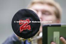 Band members have used ingenuity to cover their horn's bell. Cornhusker Marching Band practice in Co