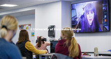 Rose Kottwitz, an Honor's Program learning assistant, adjusts the volume on lecturer Pascha Sotolong