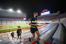 Army ROTC cadets climb the east stadium steps. UNL ROTC cadets and Lincoln first responders run the 