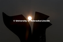 The sun rises over the Torn Notebook sculpture on city campus. September 14, 2020. 