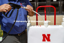 Brent Clabaugh, Zone Preventive Maint Associate with Facilities, refills a large sanitizer dispenser