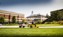Brent Clabaugh, Zone Preventive Maint Associate with Facilities, motors the customized cart towed Ha