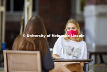 Young women hanging out at the Plaza near the Nebraska Union. Wearing masks on city campus. Septembe